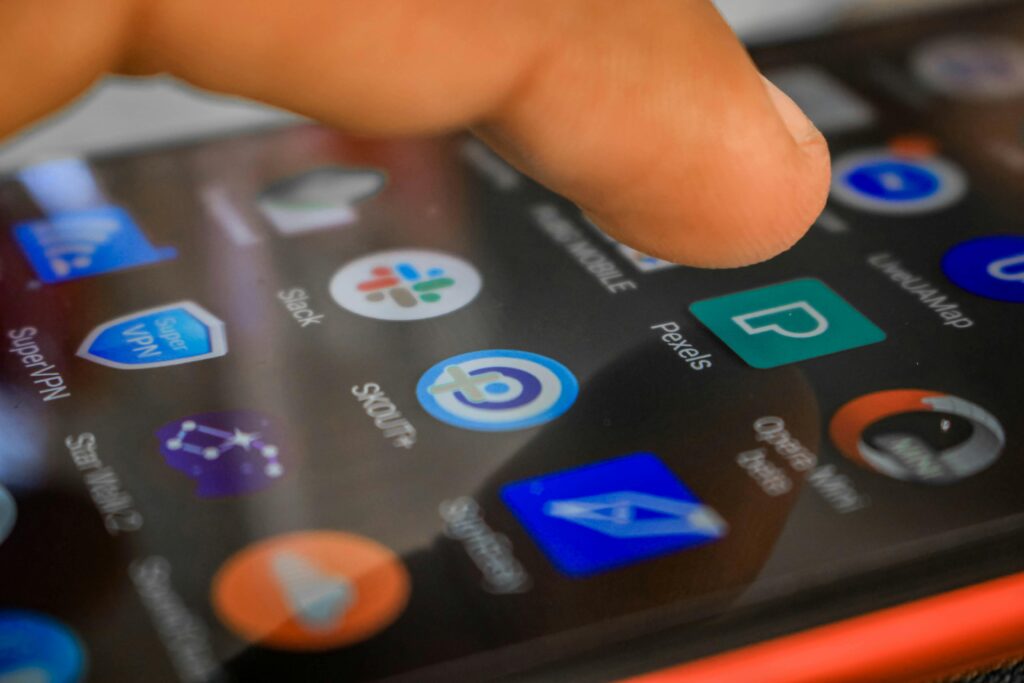 A hand interacting with a smartphone, focusing on touch screen technology and app usage.